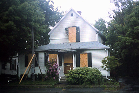 house with windows boarded up